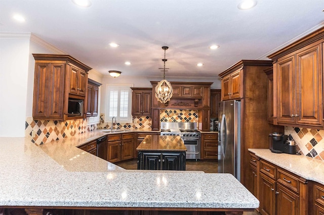 kitchen with light stone counters, stainless steel appliances, tasteful backsplash, a kitchen island, and a sink