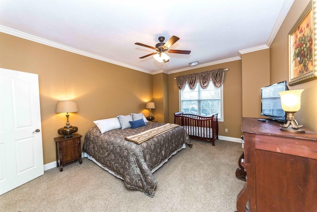 carpeted bedroom with crown molding, baseboards, and ceiling fan