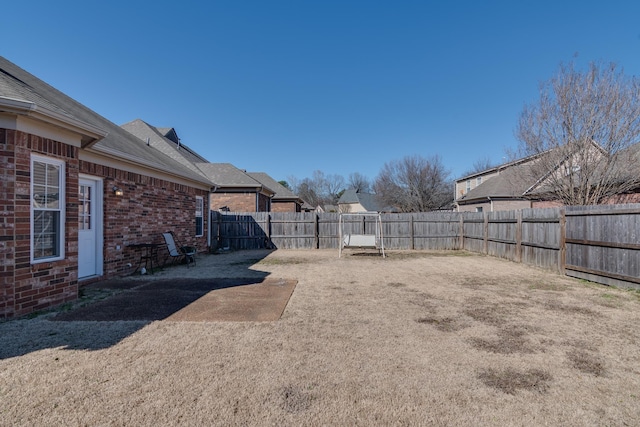 view of yard featuring a patio area and a fenced backyard