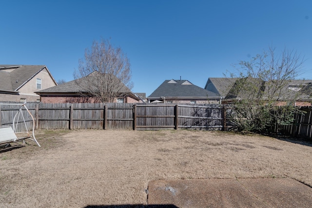 view of yard with a fenced backyard