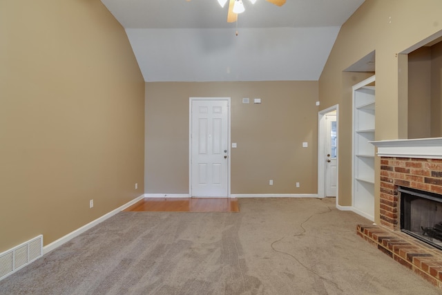 unfurnished living room featuring baseboards, visible vents, built in features, lofted ceiling, and a fireplace