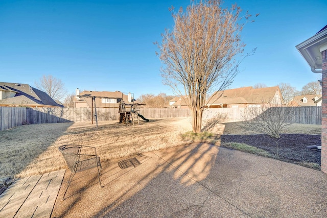 view of yard with a playground, a patio, and a fenced backyard