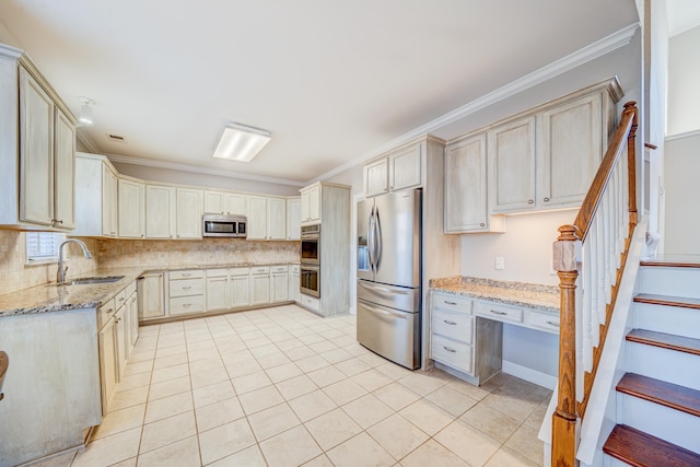 kitchen featuring light stone counters, crown molding, stainless steel appliances, decorative backsplash, and a sink