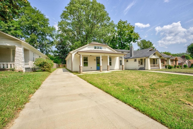 bungalow-style house with covered porch and a front lawn