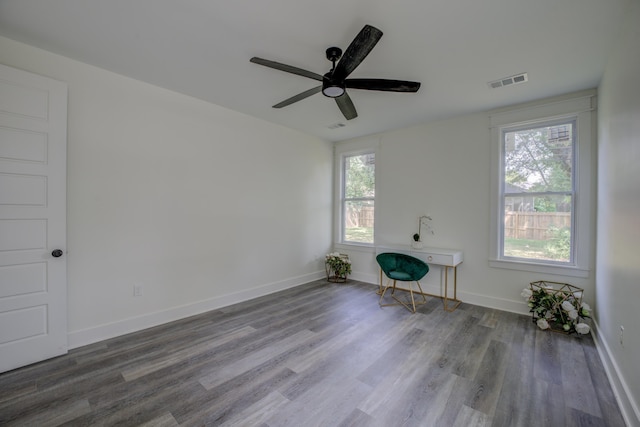 interior space featuring a ceiling fan, baseboards, visible vents, and wood finished floors