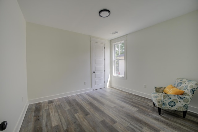 unfurnished room with visible vents, baseboards, and wood finished floors