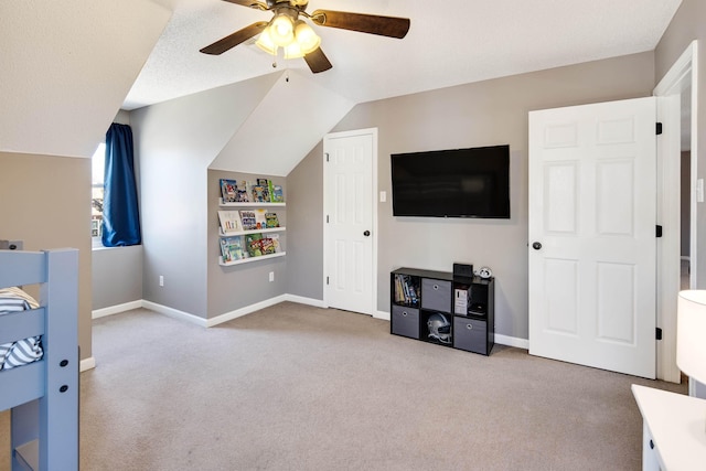 playroom with carpet floors, ceiling fan, baseboards, and vaulted ceiling