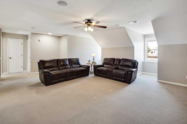 carpeted living area featuring a textured ceiling, lofted ceiling, a ceiling fan, visible vents, and baseboards