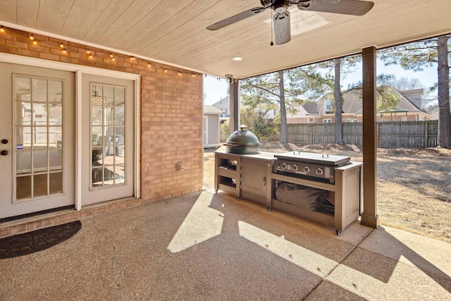 view of patio featuring a ceiling fan and fence