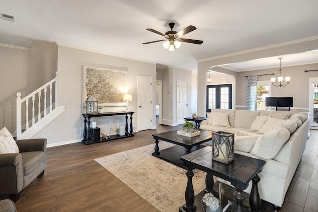 living room featuring dark wood finished floors, visible vents, stairway, baseboards, and ceiling fan with notable chandelier