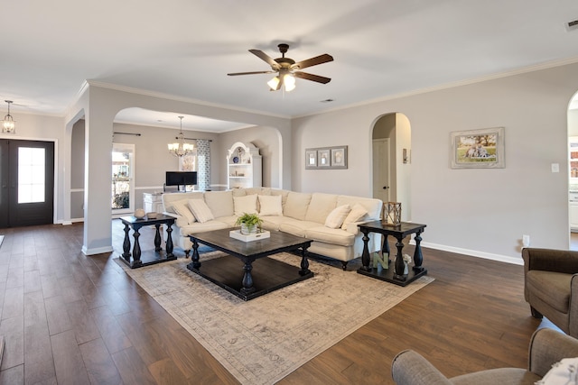 living room featuring ornamental molding, an inviting chandelier, dark wood finished floors, and baseboards