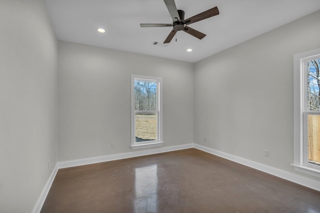 spare room featuring ceiling fan, recessed lighting, visible vents, baseboards, and finished concrete flooring