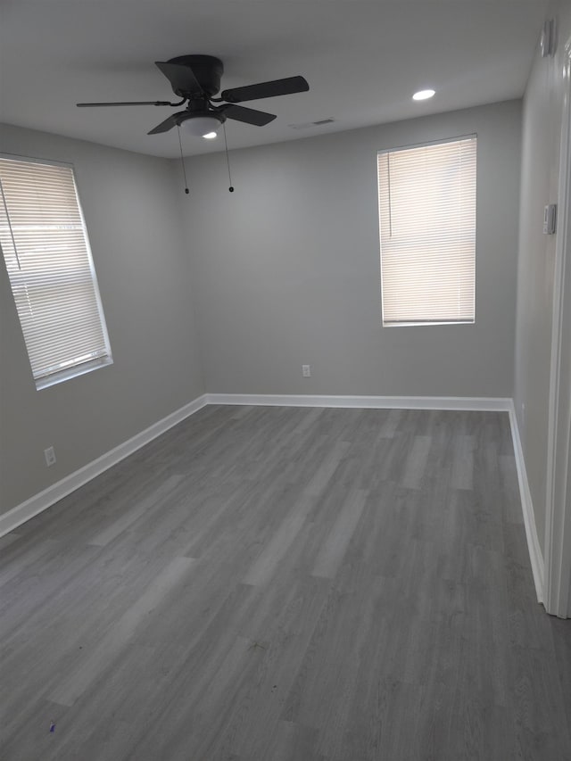 empty room with dark wood-style floors and baseboards