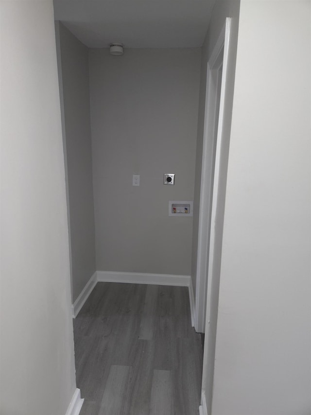 corridor with dark wood-style floors and baseboards