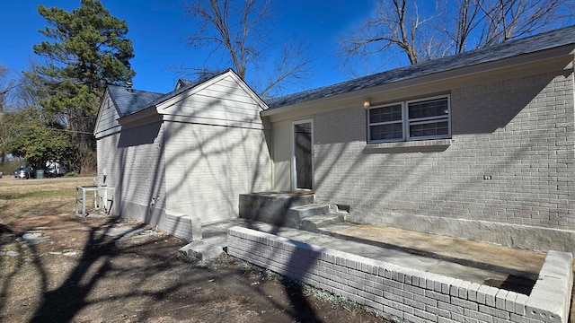 view of property exterior featuring brick siding