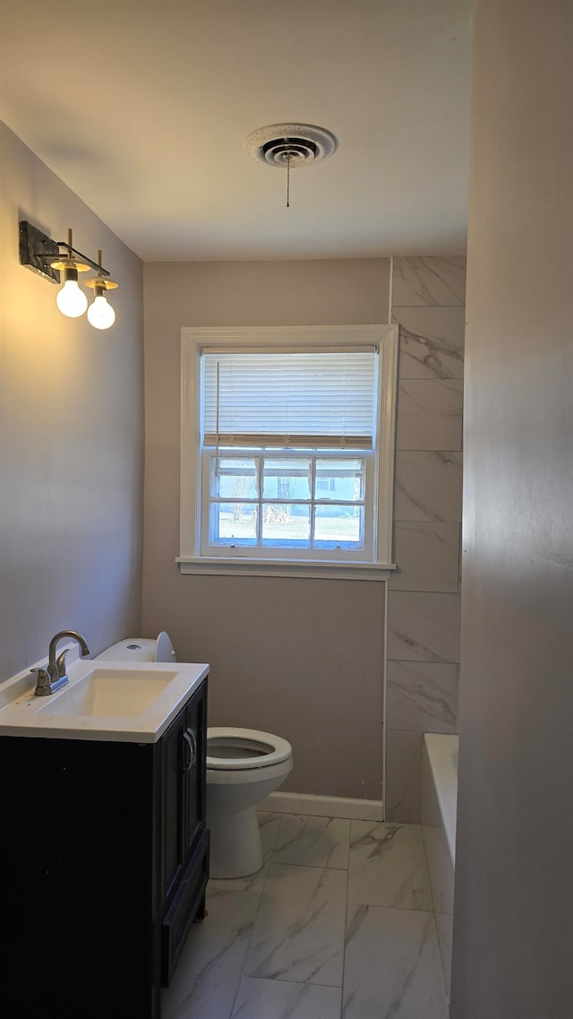 bathroom with a tub to relax in, marble finish floor, visible vents, toilet, and vanity