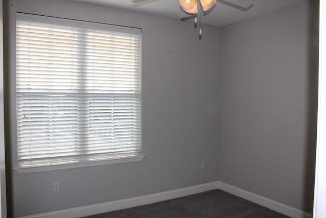 empty room featuring a ceiling fan, carpet flooring, and baseboards