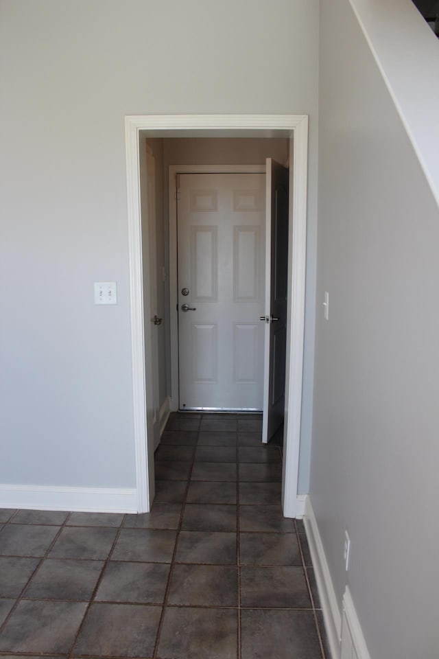 corridor featuring baseboards