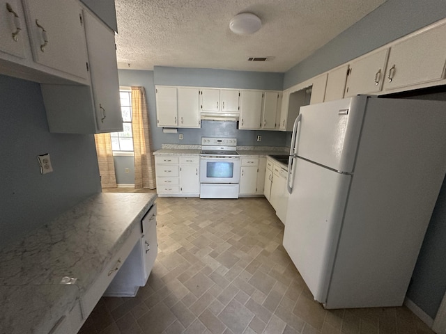 kitchen with white appliances, visible vents, light countertops, under cabinet range hood, and white cabinetry