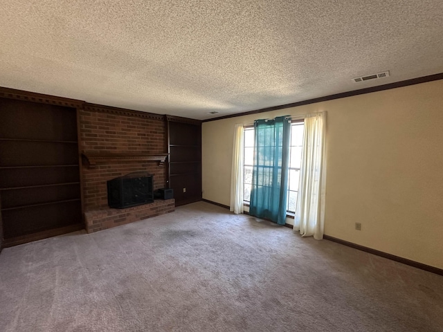 unfurnished living room featuring a fireplace, visible vents, a textured ceiling, and carpet flooring