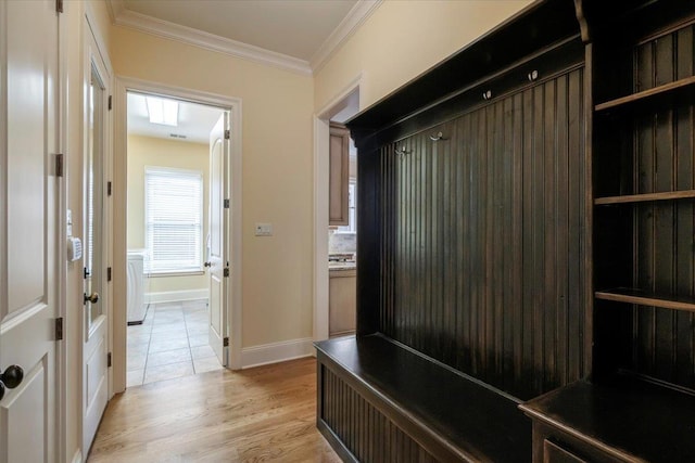 mudroom featuring light wood finished floors, baseboards, and crown molding