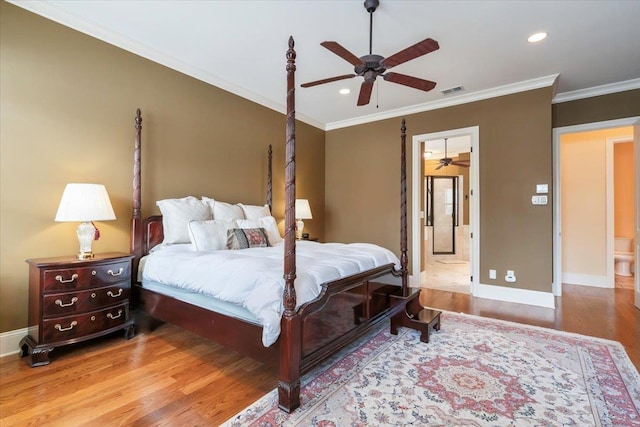 bedroom with ornamental molding, baseboards, and wood finished floors