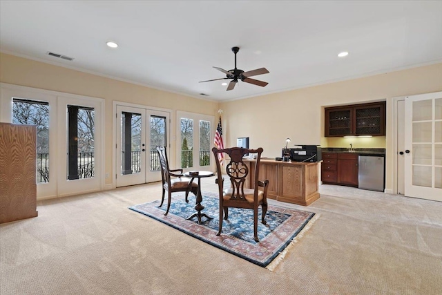 office with ornamental molding, visible vents, light colored carpet, and french doors