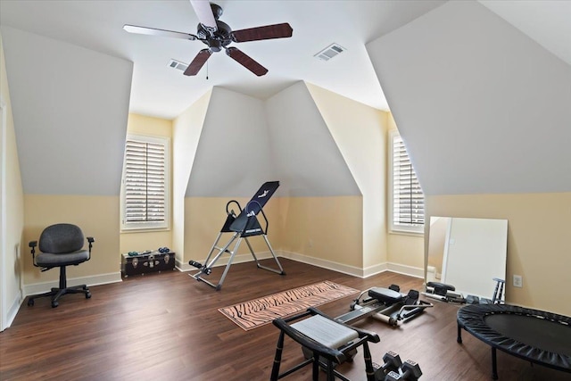 workout room with lofted ceiling, wood finished floors, visible vents, and baseboards