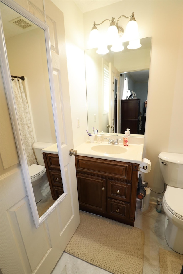 bathroom with visible vents, vanity, toilet, and tile patterned floors