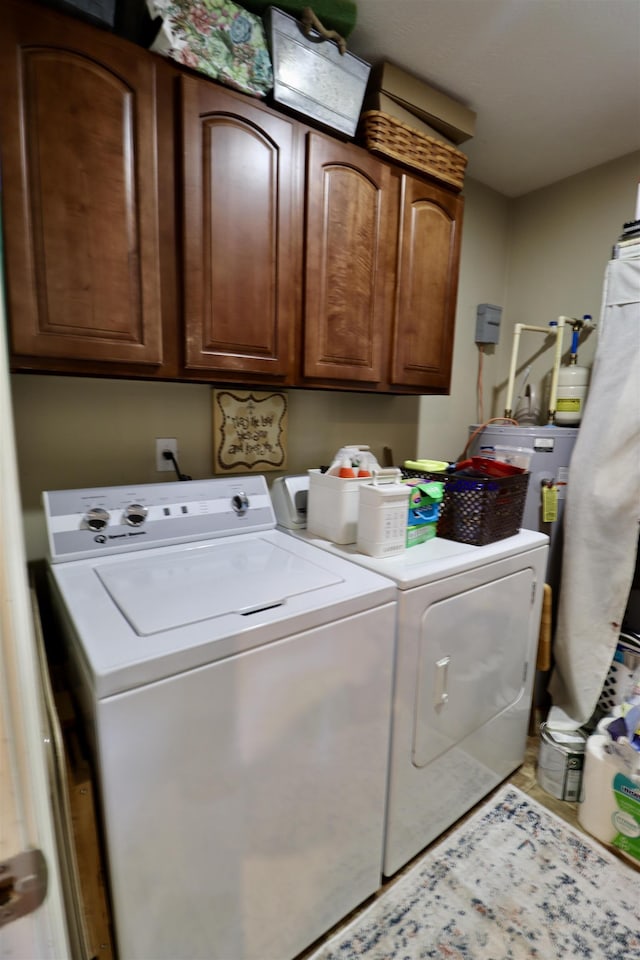 laundry area with washing machine and dryer and cabinet space