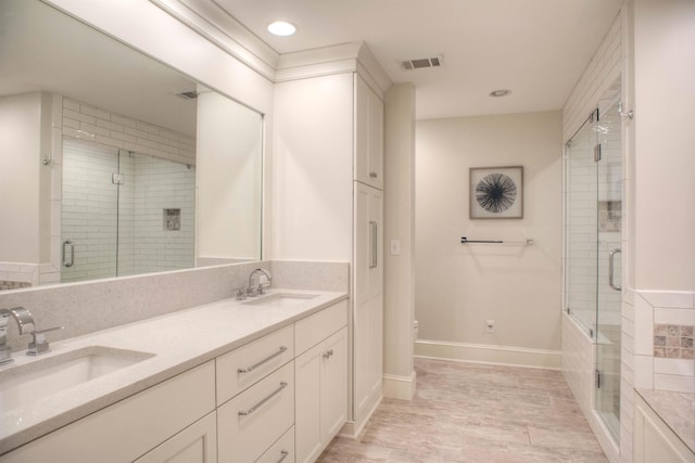 full bath featuring a stall shower, a sink, and toilet