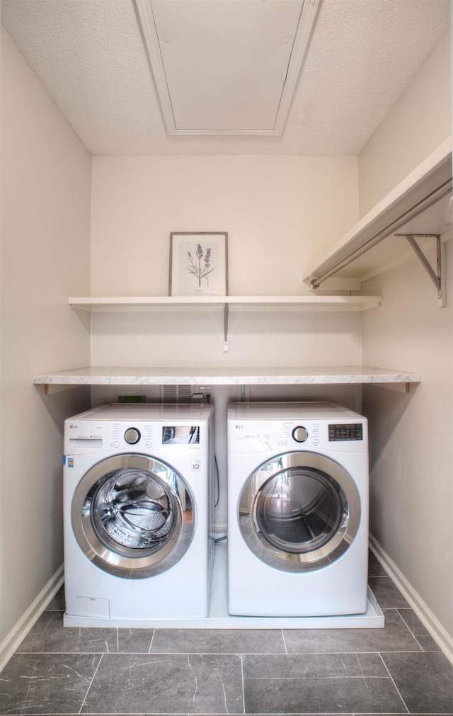 washroom with washer and dryer, laundry area, and baseboards