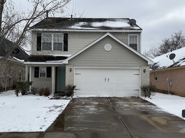 traditional-style home featuring a garage, concrete driveway, and brick siding