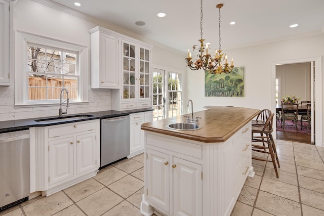 kitchen featuring decorative backsplash, a sink, and stainless steel dishwasher