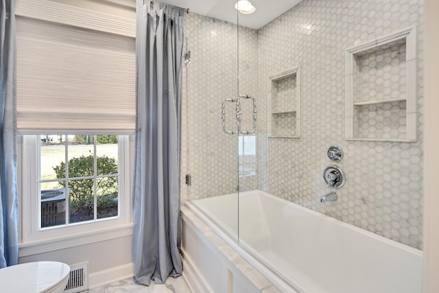 bathroom with shower / bath combination, marble finish floor, and visible vents