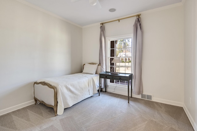 bedroom with carpet floors, visible vents, baseboards, and crown molding