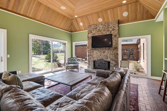 living room featuring high vaulted ceiling, a stone fireplace, brick floor, recessed lighting, and wood ceiling