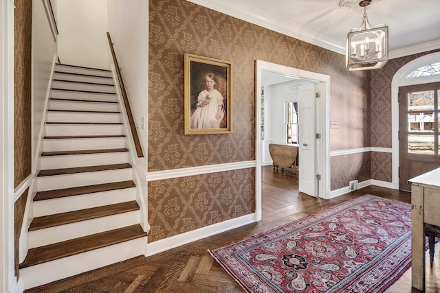 entryway with wallpapered walls, an inviting chandelier, ornamental molding, baseboards, and stairs