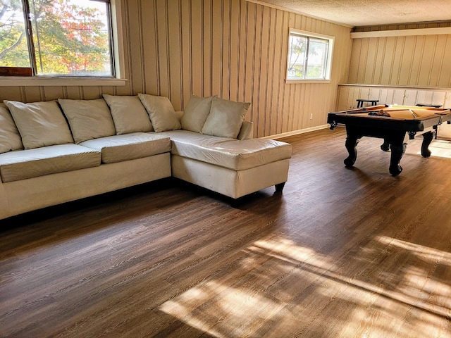 living room featuring pool table, wood walls, and wood finished floors