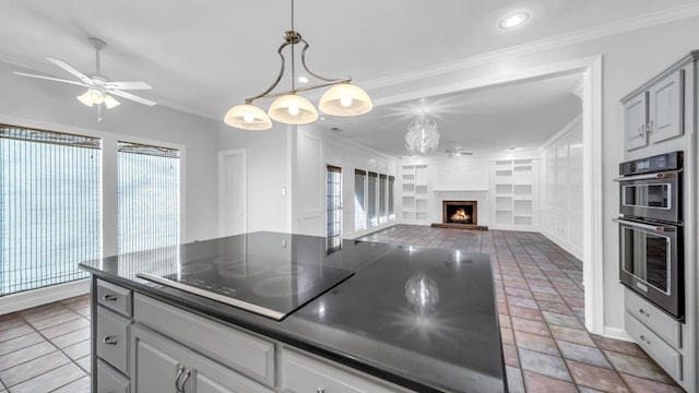 kitchen with double oven, black electric cooktop, built in features, a lit fireplace, and ornamental molding