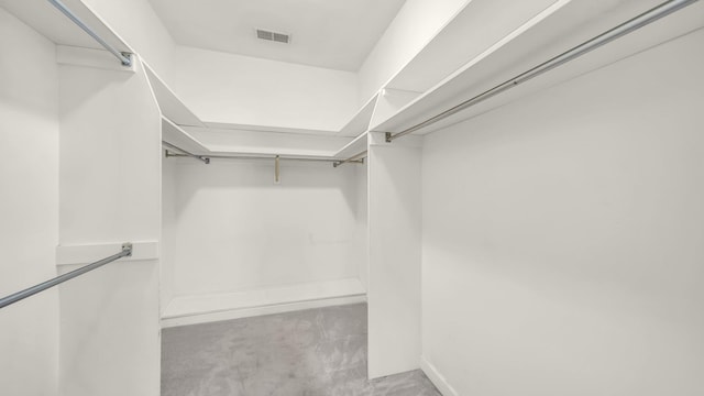 spacious closet with carpet floors and visible vents