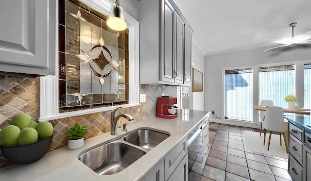 kitchen featuring light tile patterned floors, light countertops, gray cabinets, and a sink