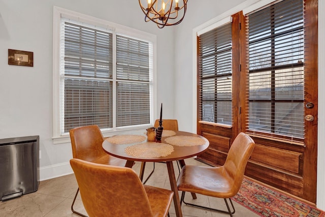 dining area with baseboards and an inviting chandelier