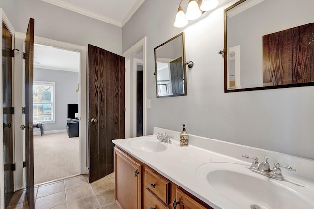 bathroom featuring double vanity, crown molding, a sink, and tile patterned floors