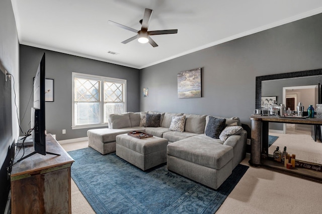 carpeted living area with ornamental molding, visible vents, baseboards, and a ceiling fan