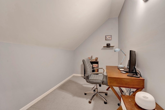 carpeted home office with lofted ceiling and baseboards