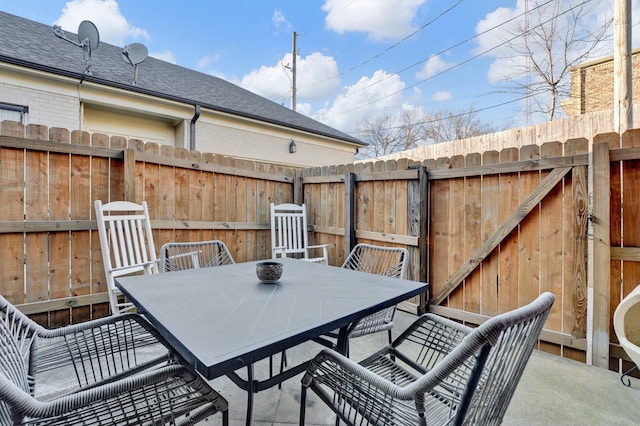 view of patio / terrace with outdoor dining area and fence