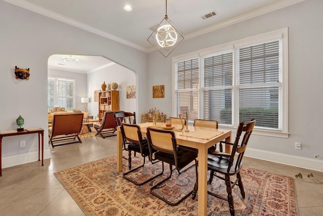 dining space featuring arched walkways, light tile patterned floors, visible vents, baseboards, and crown molding