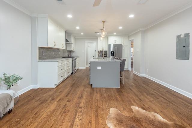 kitchen featuring stainless steel appliances, electric panel, ornamental molding, and tasteful backsplash