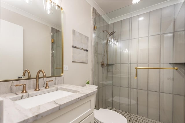 bathroom featuring toilet, tiled shower, and vanity